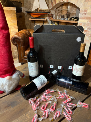 Cabernet & Bordeaux Adventskalender 2026 – L.A. Cetto Cabernet Sauvignon, Château Pierrail, Château Teyssier og Villa Bel-Air foran sort lugeæske med sukkerstokke